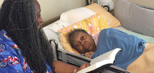 nurse reading book to patient